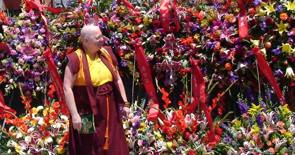 Zhaxi Zhuoma inspects the myriad of flowers sent to mark the coming to the temple of the much awaited treasure book.