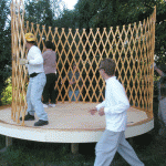 Students erect walls to yurt.