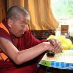 H.H. Dharma King Jigme Dorje stamps his seal onto his congratulatory letter to H.H. Dorje Chang Buddha III that he had already signed.