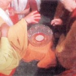 Dharma Master Wu Ming removes the lid from the nectar bowl as others look on