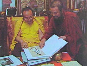 H.E. Tai Situ Rinpoche XII looking at book of H.H. Dorje Chang Buddha III's paintings